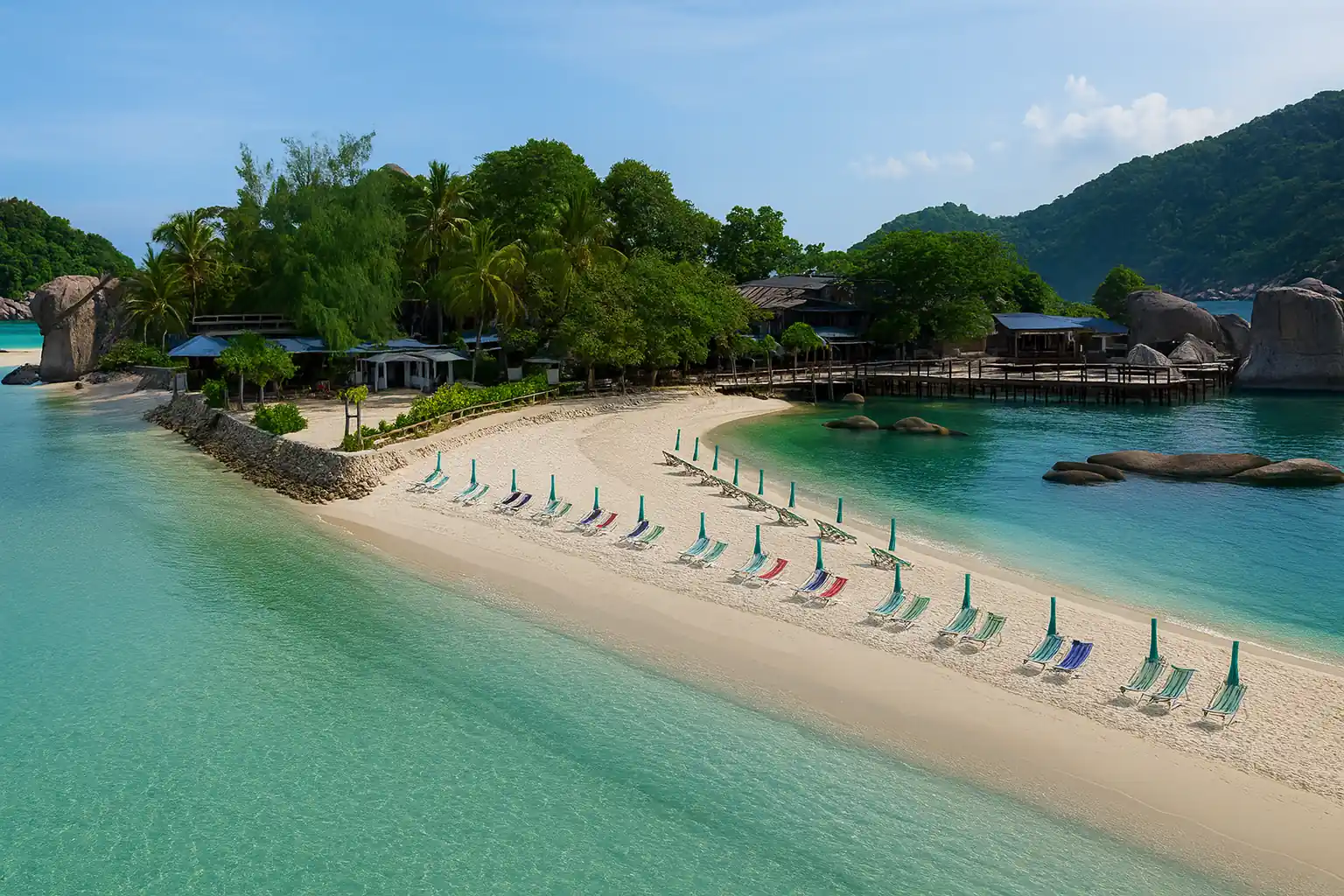 Beach loungers and umbrellas along turquoise bay at Koh Nangyuan